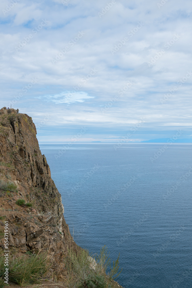 Beautiful summer landscape of Baikal Lake on sunny day. View of the rocky cape Beautiful summer landscape of Baikal Lake on sunny day. View of the rocky cape
