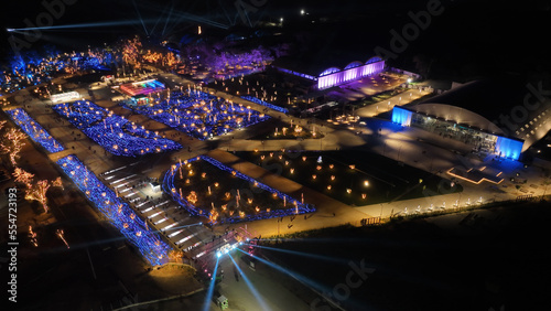 Aerial drone night distant shot from illuminated with Christmas lights futuristic Ellinikon Experience public Park an urban regeneration project and cultural center in Athens riviera, Attica, Greece photo