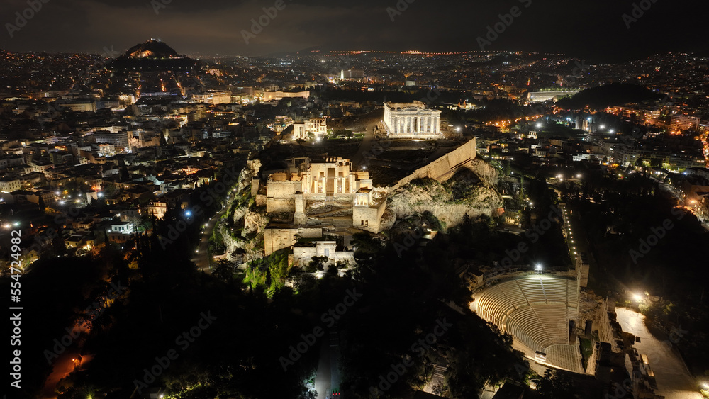 Aerial drone night shot of iconic illuminated landmark Acropolis hill and the Masterpiece of Ancient times and Western civilisation - the Parthenon, Athens historic centre, Attica, Greece