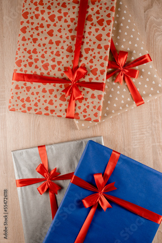 Gift boxes with red bow and silk ribbon for Christmas present. New Year gifts packaged in gift box for the winter holidays.