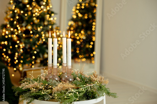 4 candles in a green wreath. Advent wreath with all 4 candles lit