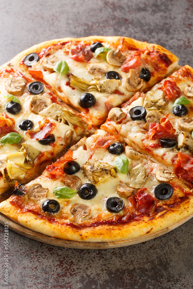 Pizza capricciosa with white mushrooms, ham, artichoke, tomatoes, olives, parmesan and mozzarella on wooden board on the table. Vertical