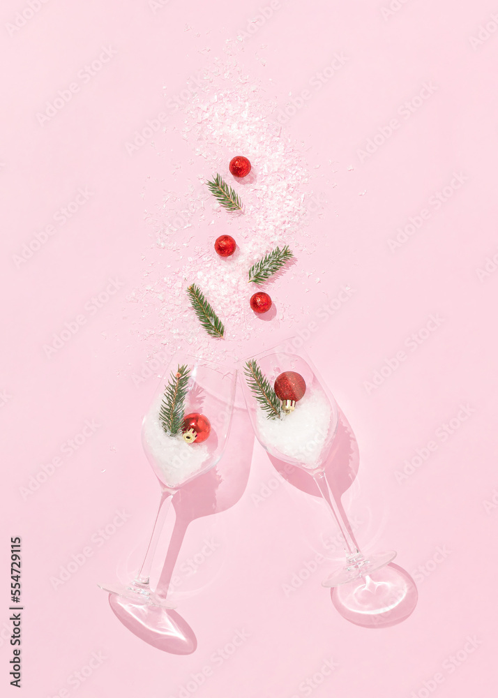 Christmas layout made of two wine glasses with red Christmas balls, fir branches and snow on bright pink background. Minimal New Year celebration concept. Creative winter party aesthetic. Christmas layout made of two wine glasses with red Christmas balls, fir branches and snow on bright pink background. Minimal New Year celebration concept. Creative winter party aesthetic.