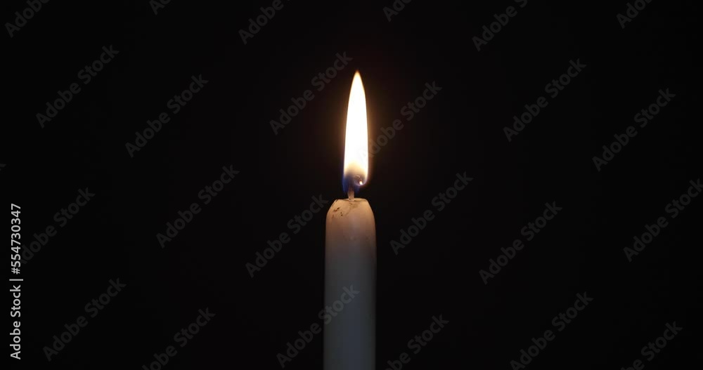 burning candle on a dark background