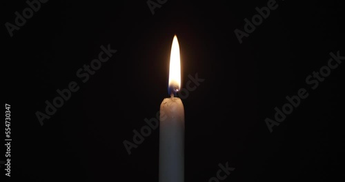 burning candle on a dark background