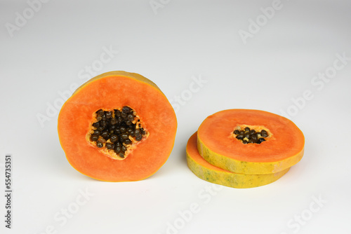 ripe papaya slice with seeds isolated on white background