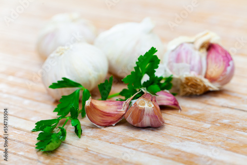 Parsley and garlic on wooden table. Preparing food concept.