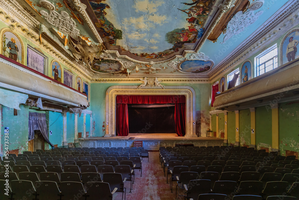 Fotografie Old abandoned ruined stage theater with paintings on ceiling and walls