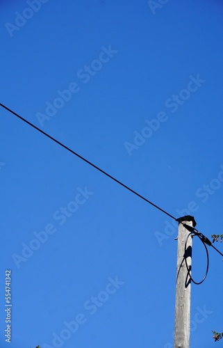 Power cable in front of the blue sky
