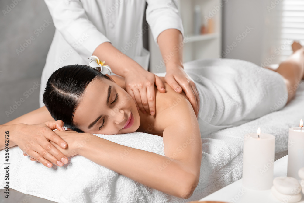Beautiful woman receiving back massage in beauty salon, closeup Beautiful woman receiving back massage in beauty salon, closeup