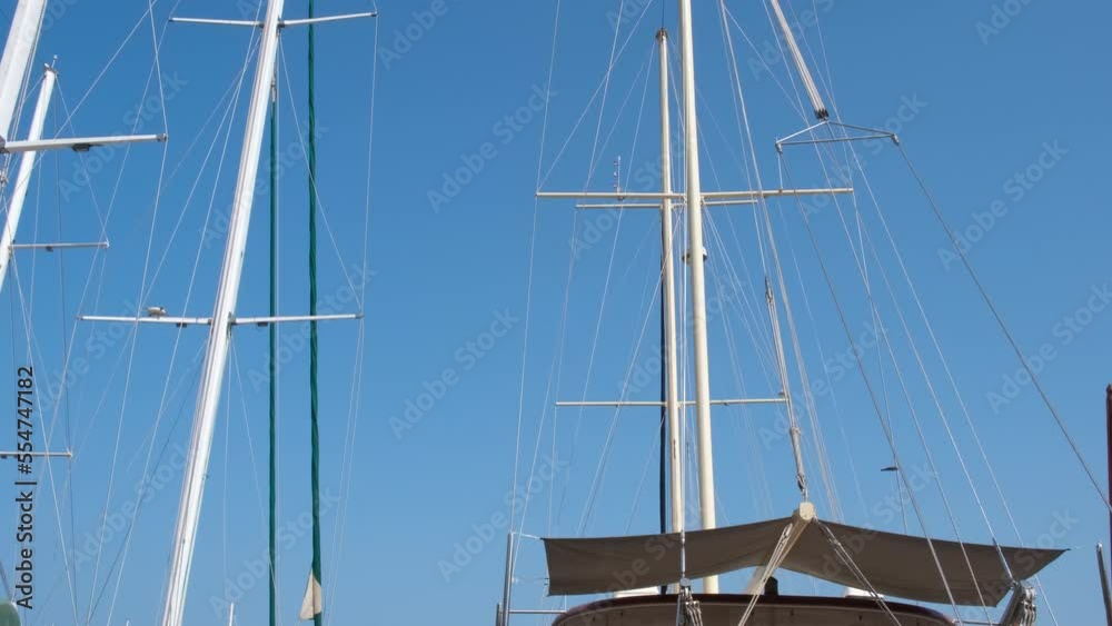 Boat without sails against sea. A view of luxury wooden yachts without sail moored by the sunny beach. Boat without sails against sea. A view of luxury wooden yachts without sail moored by the sunny beach.