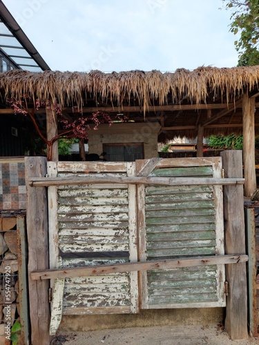 The exterior of thatched house on beach with clear sky photo