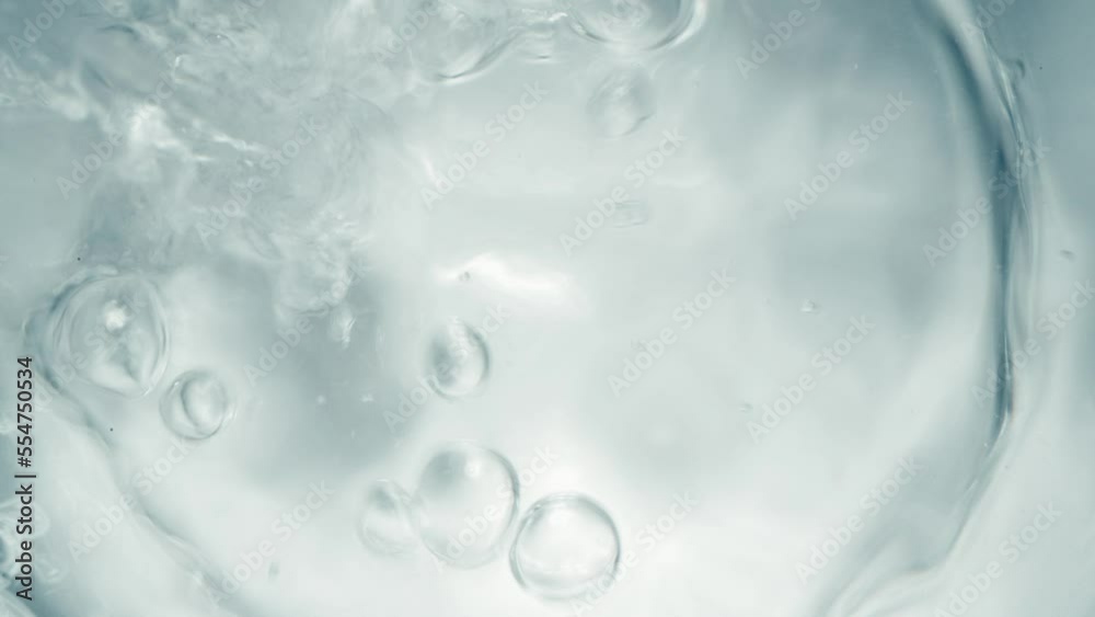 Pure Water Poured Into Glass closeup on light gray background. Super slow motion. Quenching thirst concept. Clear fresh drinking water filling glass close up Pure Water Poured Into Glass closeup on light gray background. Super slow motion. Quenching thirst concept. Clear fresh drinking water filling glass close up