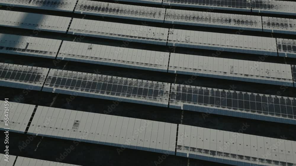 Solar panels of solar power plant covered in snow and ice, partly defrosted, slow orbit drone shot Solar panels of solar power plant covered in snow and ice, partly defrosted, slow orbit drone shot
