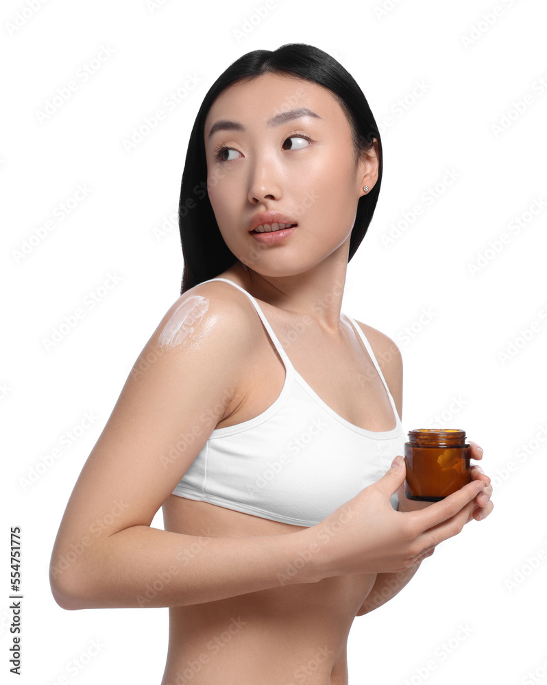 Beautiful young Asian woman applying body cream onto shoulder on white background Beautiful young Asian woman applying body cream onto shoulder on white background