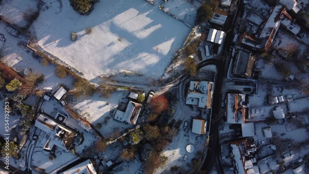 Looking down on a snow covered village in winter sunshine Looking down on a snow covered village in winter sunshine