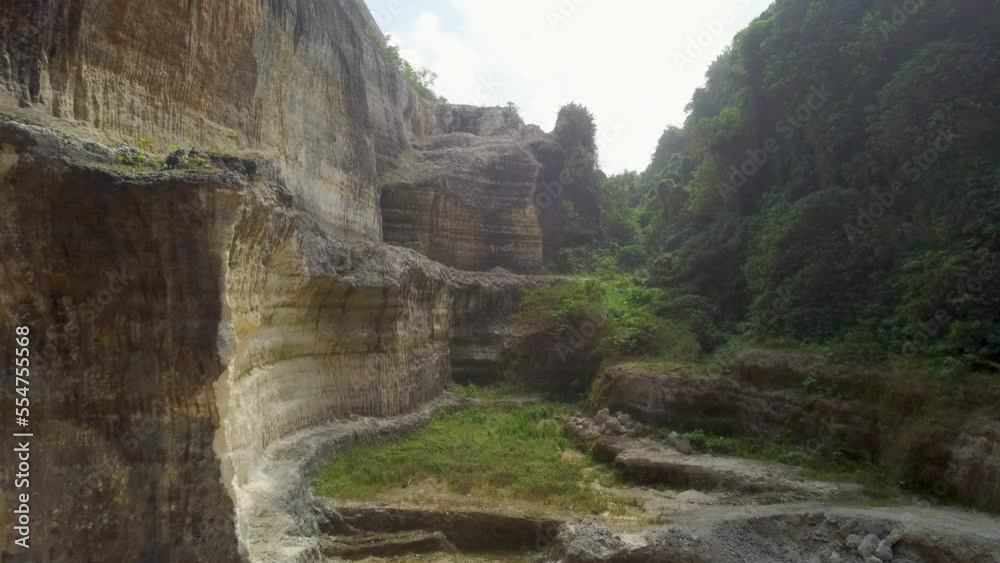 AERIAL: Drone shot flying through a cliff in Bali AERIAL: Drone shot flying through a cliff in Bali