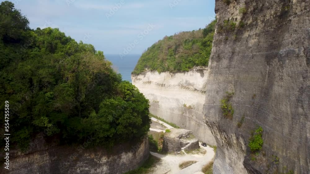 AERIAL: Drone shot flying through mountians to reveal a beautiful Beach AERIAL: Drone shot flying through mountians to reveal a beautiful Beach