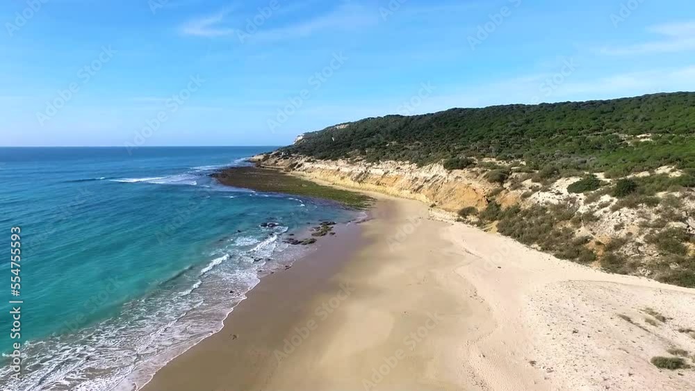 Aerial view rising above Spanish Playa Cabello golden sandy beach and lush woodland mount coastline Aerial view rising above Spanish Playa Cabello golden sandy beach and lush woodland mount coastline