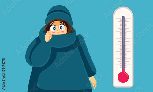 Woman Feeling Cold Next to a Freezing Thermometer Vector Cartoon. Unhappy girl disliking bad freezing season wearing warm clothing 
