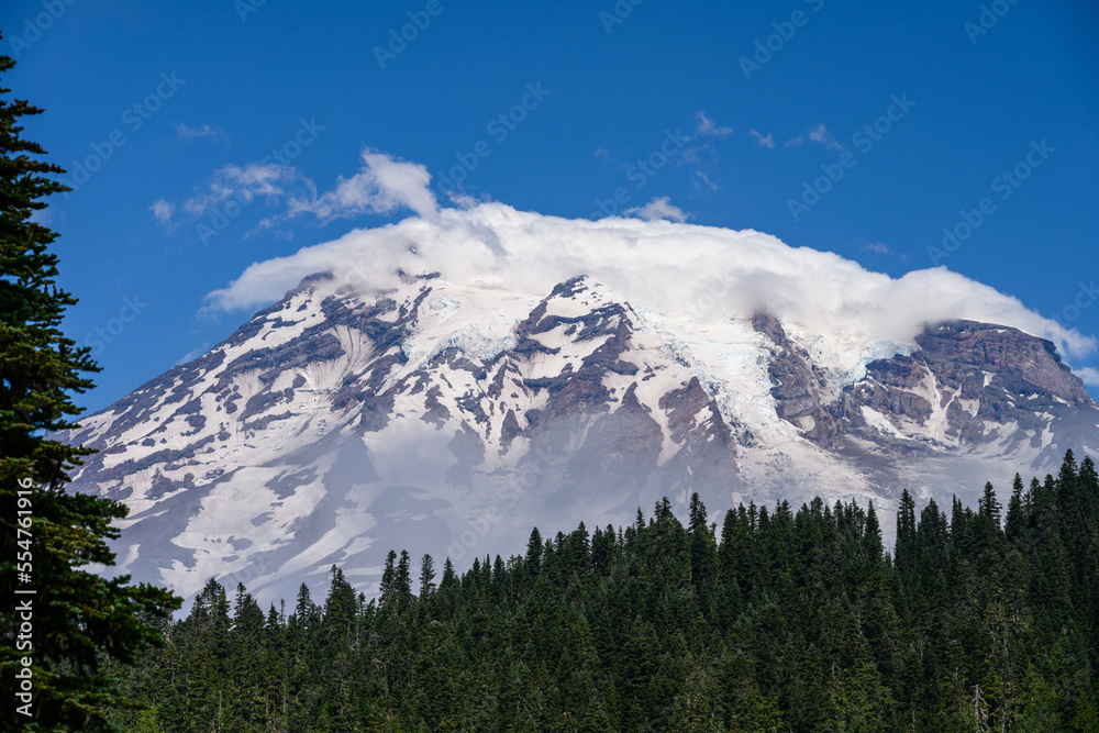 View of the snow and glacier covered peak of Mt. Rainier on a sunny summer day
