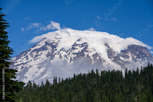 View of the snow and glacier covered peak of Mt. Rainier on a sunny summer day 