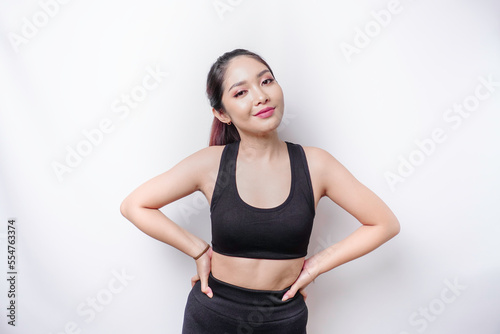 Shot of a sporty young confident woman posing against a white background. © Reezky