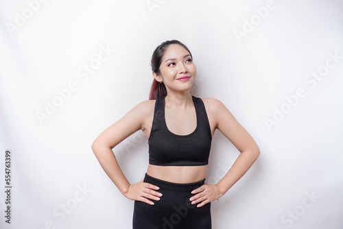 Shot of a sporty young confident woman posing against a white background. © Reezky