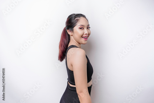 A portrait of a sporty Asian woman wearing a sportswear isolated by white background