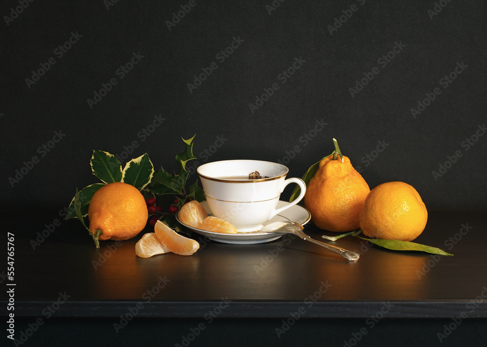 Holly, Tea and Mandarins on a dark Background Holly, Tea and Mandarins on a dark Background