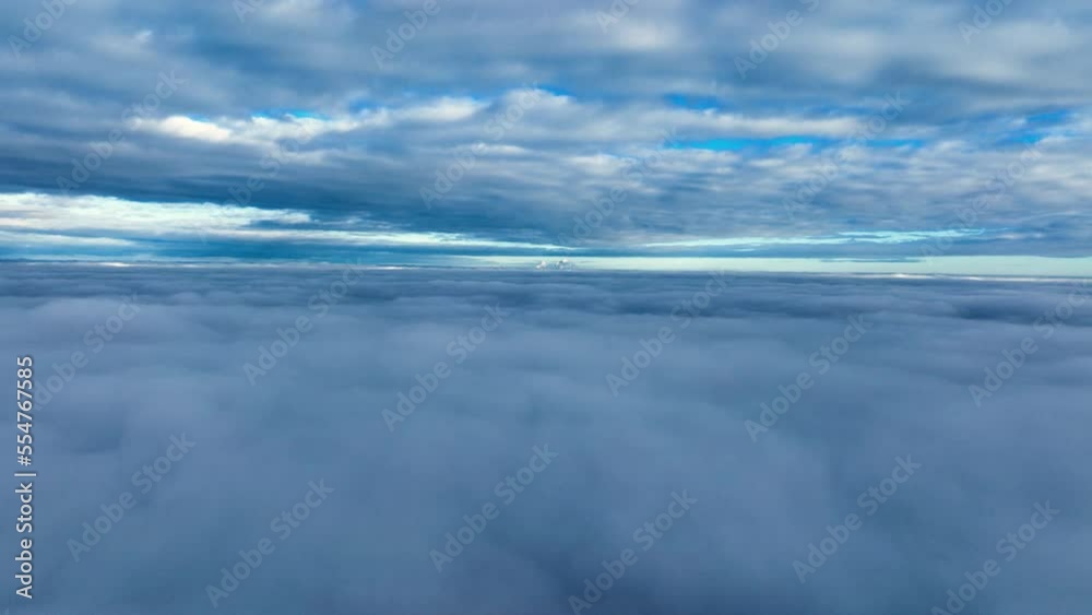 Mirror image of clouds in beautiful sky - drone flight between two cloud layers Mirror image of clouds in beautiful sky - drone flight between two cloud layers