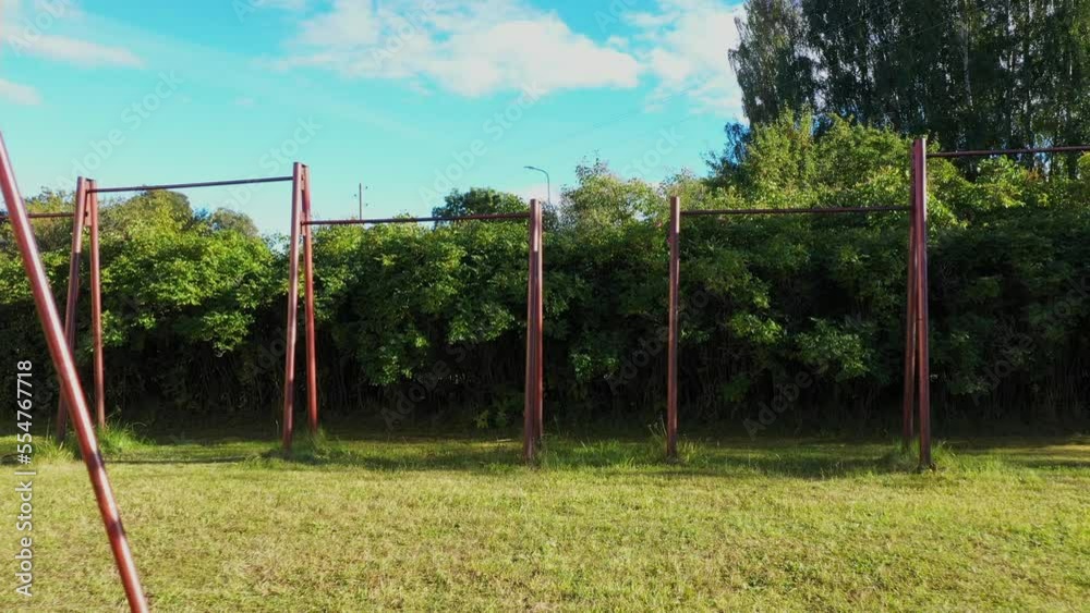 Old Soviet built outdoor gym in local park, dolly backward view Old Soviet built outdoor gym in local park, dolly backward view