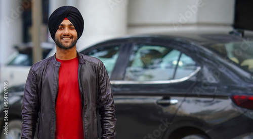 happy Indian Young sikh punjabi boy going office photo