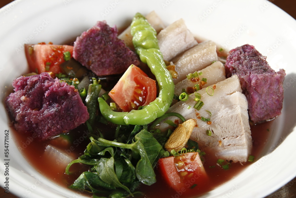 Pork sinigang with ube, a soup from the Philippines made from pork, varous vegetables and tamarind-based soup