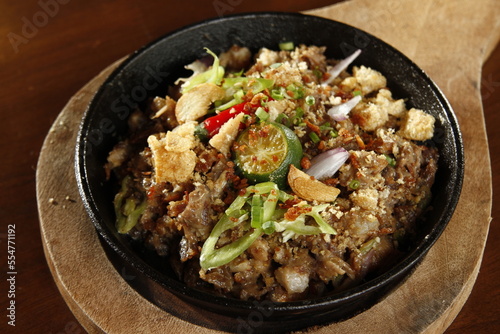 Sizzling pork sisig, a dish from the Philippines made from chopped pig ears and snout, with onions, peppers, pork cracklings and kalamansi