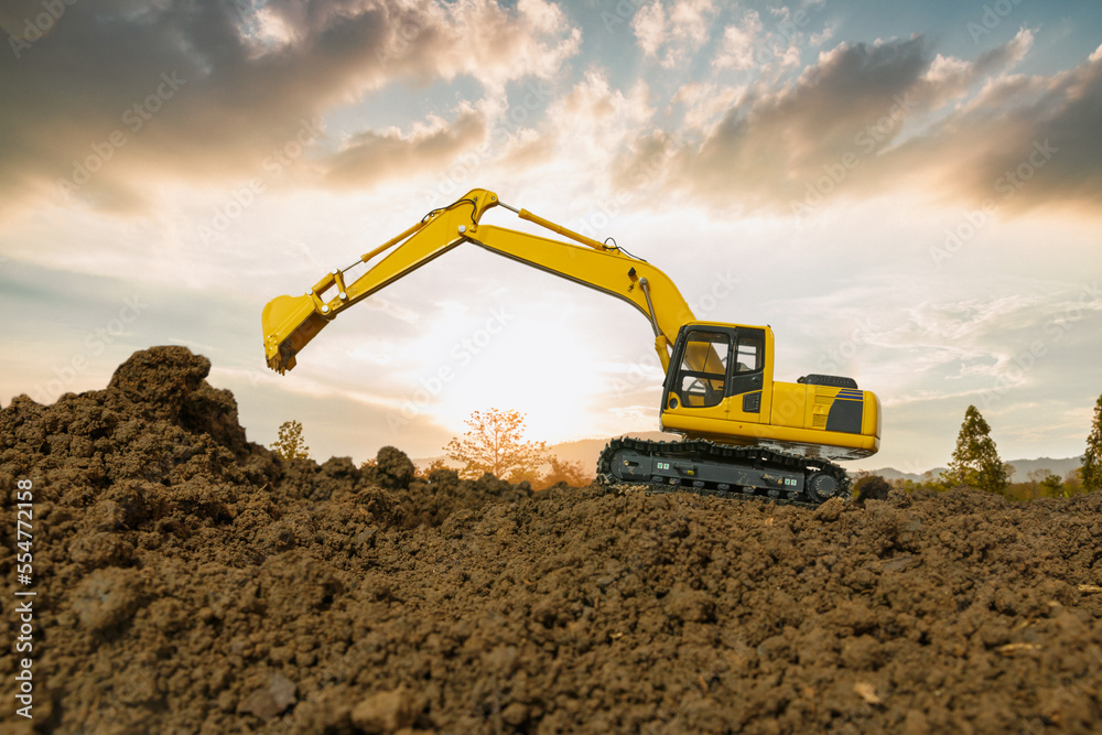 Crawler Excavators are bucket lift up in the construction site on the sunset sky backgrounds. Crawler Excavators are bucket lift up in the construction site on the sunset sky backgrounds.