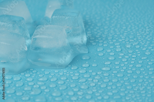 ice cubes with water drops close-up on a blue background