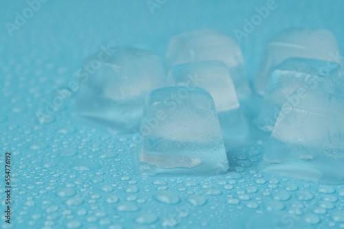 ice cubes with water drops close-up on a blue background