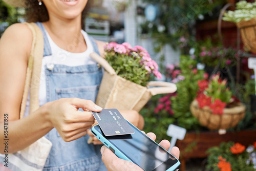 Tableau sur toile Customer, shopping and credit card for florist shop payment with POS machine or phone for sale of flowers at small business