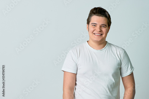 A man on a light background smiles. Emotions. Сopy space