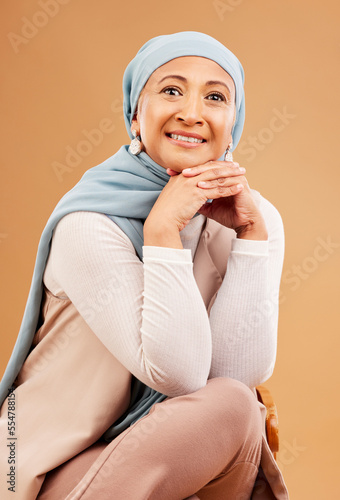 Photography Hijab, fashion and senior Muslim woman with a smile, confidence and happiness on a brown studio background