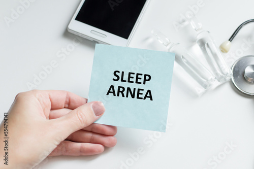 Sleep Arnea written on label tag with Stethoscope on white background photo