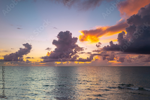 Cloudy sky on sea sunset, sunrise on ocean beach. Sunset landscape in the sky after sunset. Sunrise with clouds of different colors against the sky and sea.