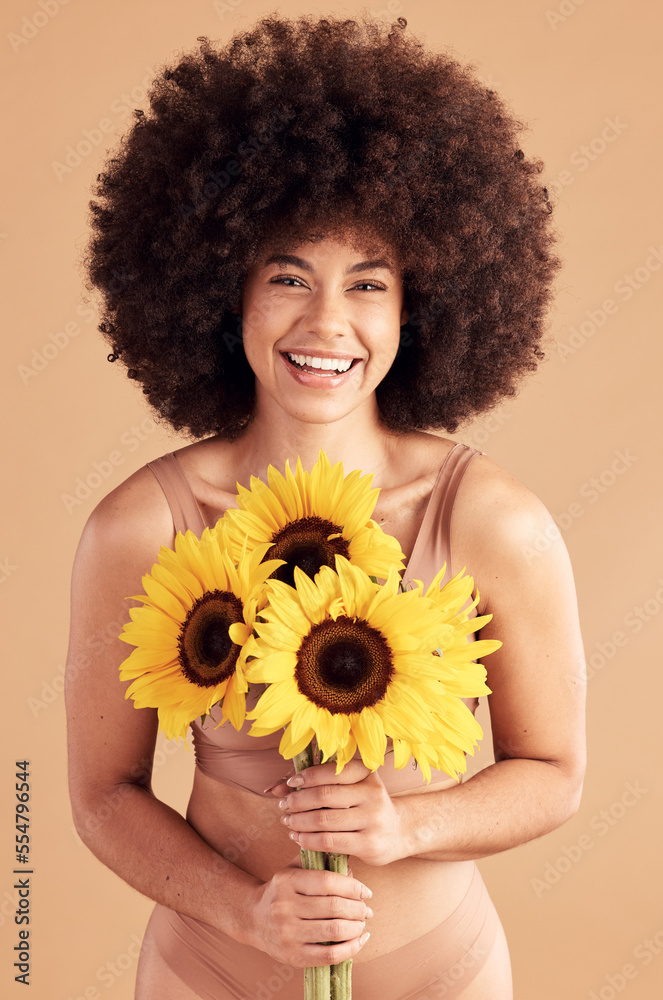 Beauty, skincare and black woman with sunflower, smile and natural hair on  a studio background for cosmetics, makeup and self love. Portrait afro  female with flowers for spring dermatology and glow foto