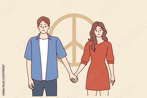 Man and woman dressed in casual style hold hands standing near symbol of pacifism. Friendly guy and girl posing near sign symbolizing peace and disarmament. Flat vector illustration
