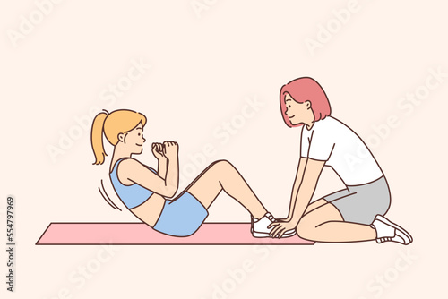 Woman training with coach in gym