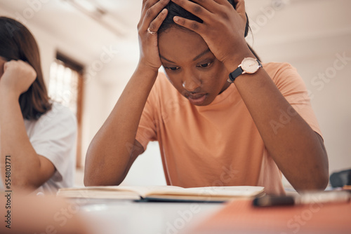 Exam stress, studying and student reading, classroom learning and headache from education. Anxiety, books and African girl with fear of fail on a test, adhd problem and frustrated with school