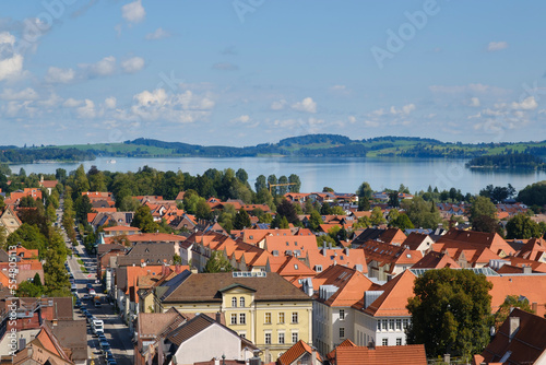 Germany, Bavaria, Fussen, Residential buildings withForggensee Lake in background photo