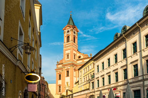 Germany, Bavaria, Passau, Bell tower of Church of St. Paul and surrounding buildings photo