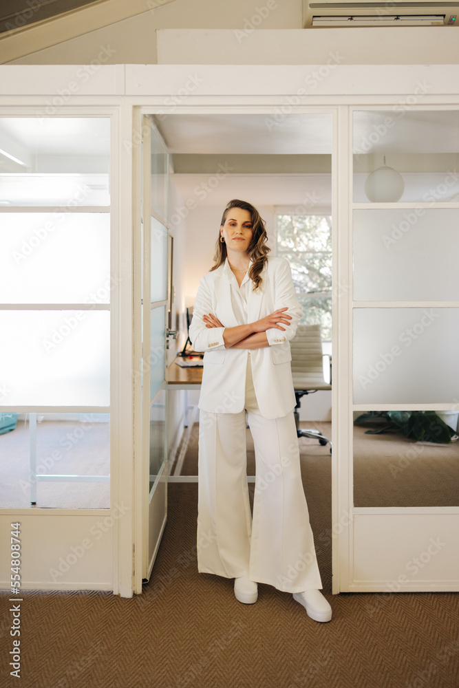 Confident business professional standing with her arms crossed Confident business professional standing with her arms crossed
